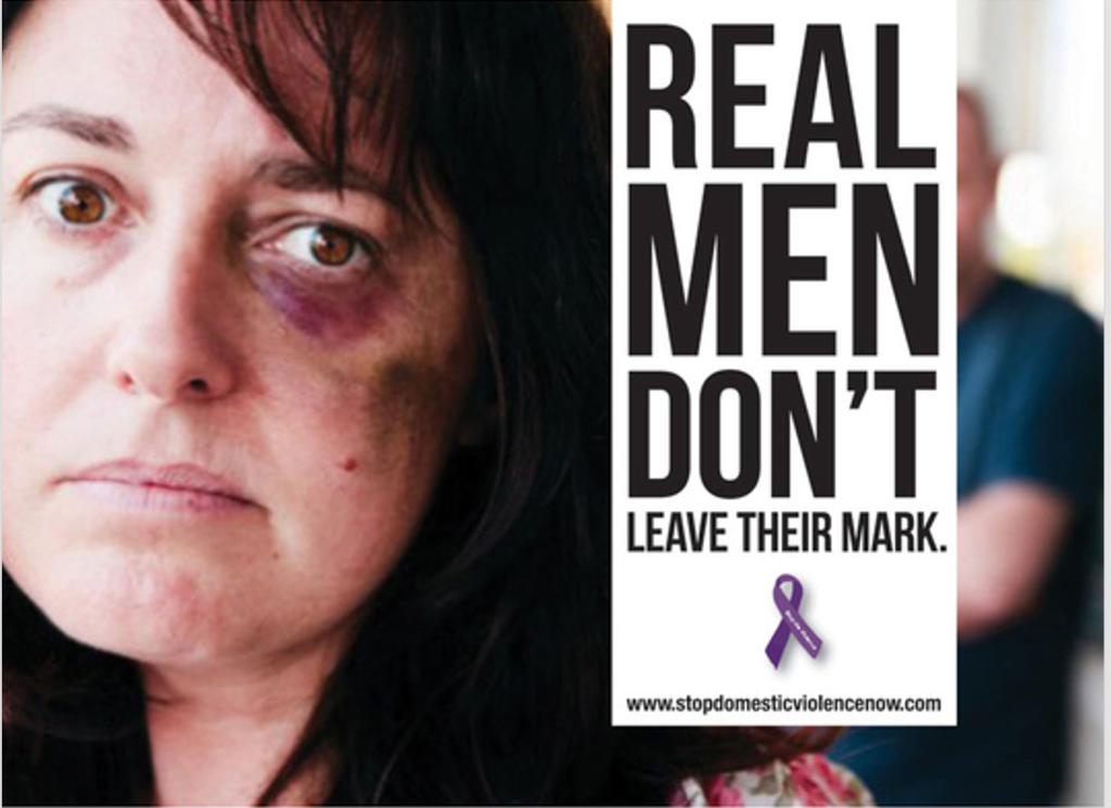 ID: A woman's bruised and battered face, with a blurry figure in the background. Text reads REAL MEN DON'T LEAVE THEIR MARK. 